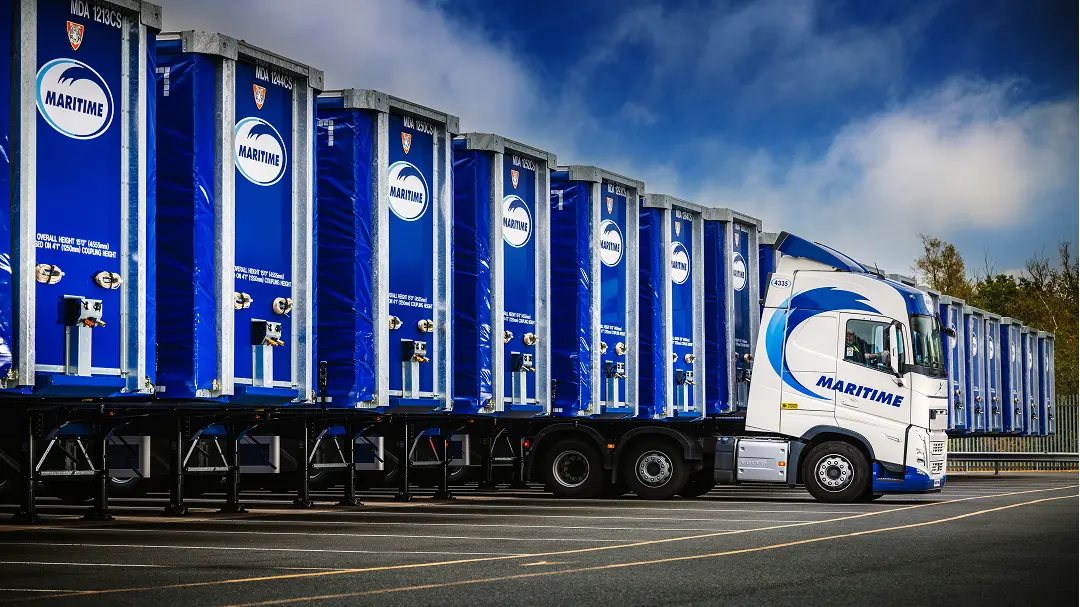 Curtainsiders lined up with a vehicle ready to transport