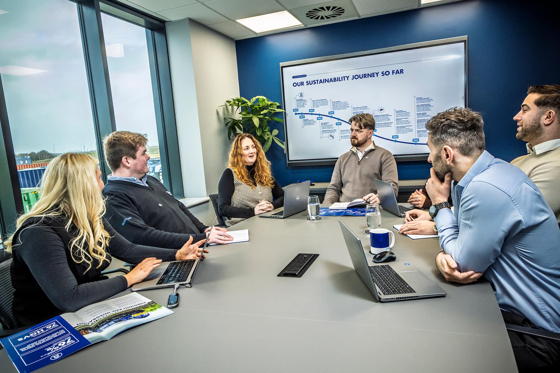 A group of office workers attending a business meeting.