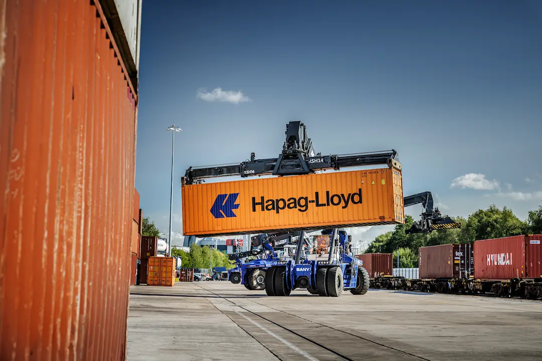 Hapag-Lloyd container being transported by a Maritime Transport reach stacker.