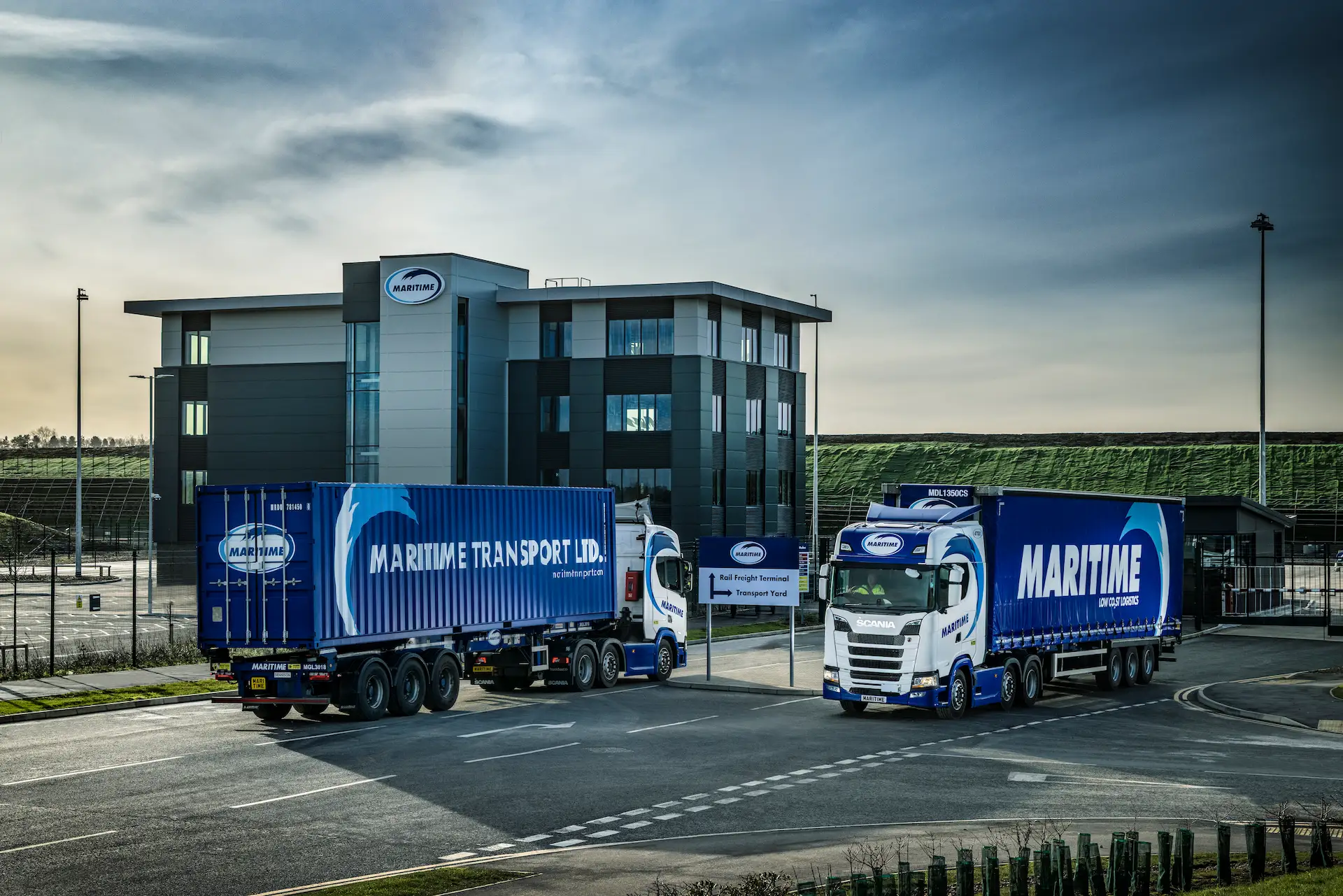 Maritime Transport vehicles driving in front of a Maritime building.