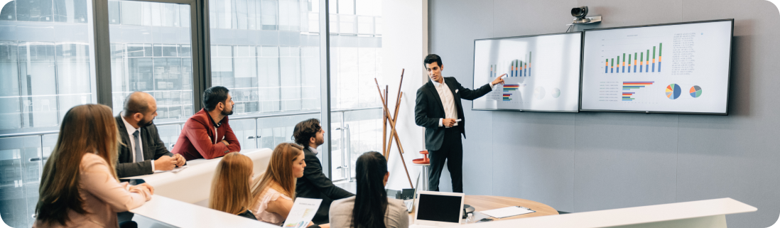 A meeting room which is showing business dashboard