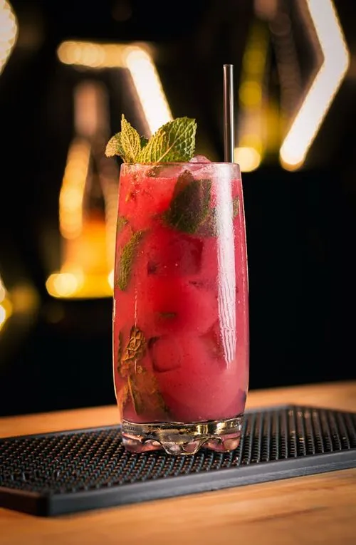 A drink with a green leaf on top of it.