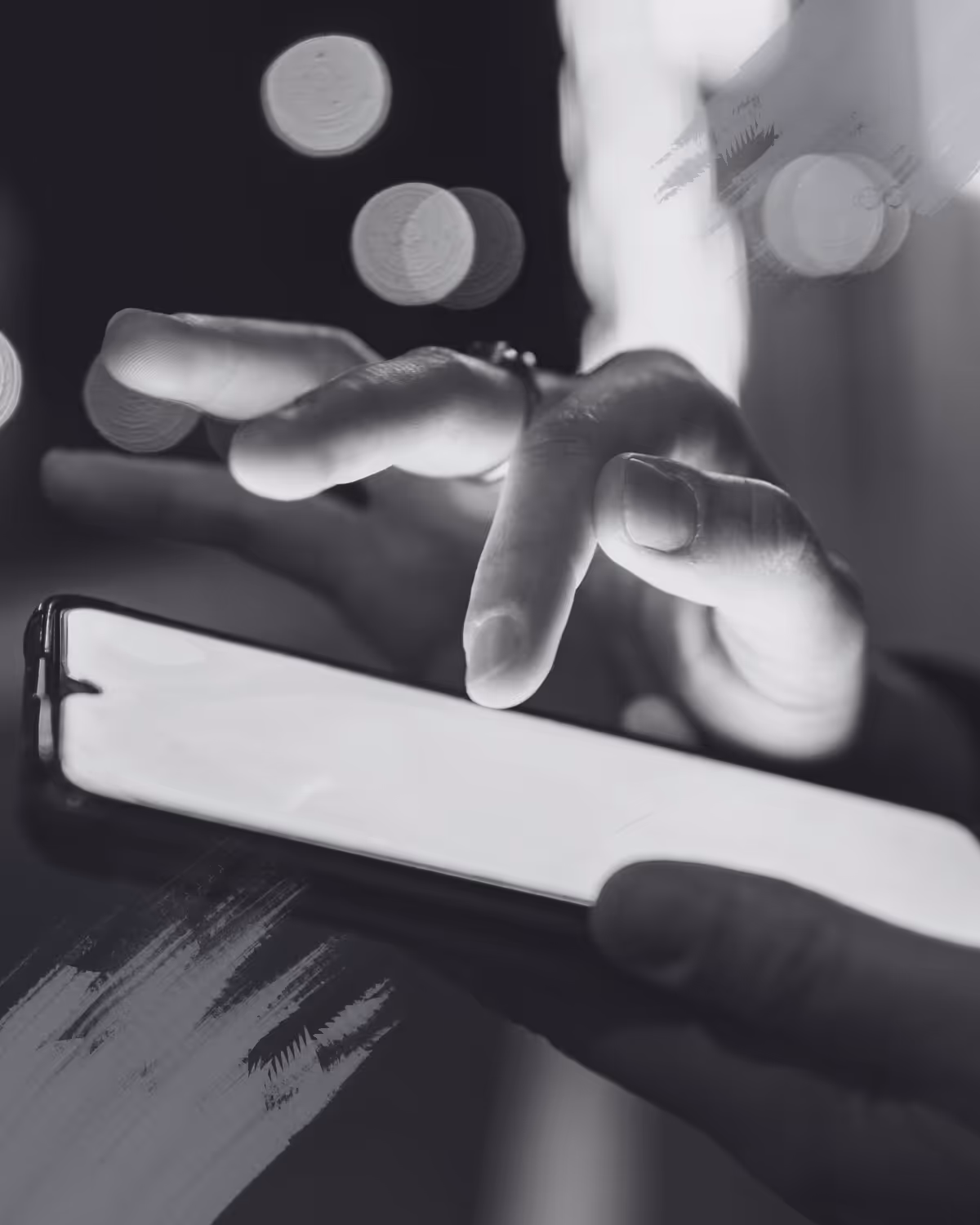 A person typing on a mobile phone screen.