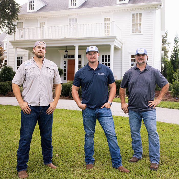 Elle Gray Construction team standing in front of The Colonial at Sunset in Tampa Bay, Florida
