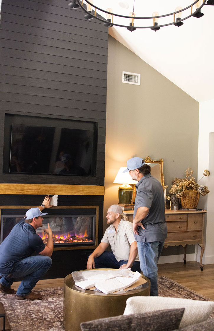 Home builders discussing fireplace installation details during a custom home project in Tampa Bay, Florida