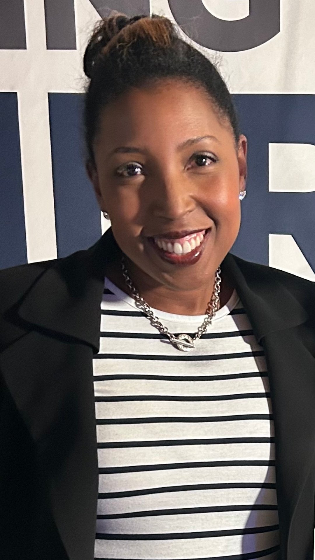 A photo f Kevin Milfeld - Board President of RISE Hybrid Academy in a blue suit and white shirt.