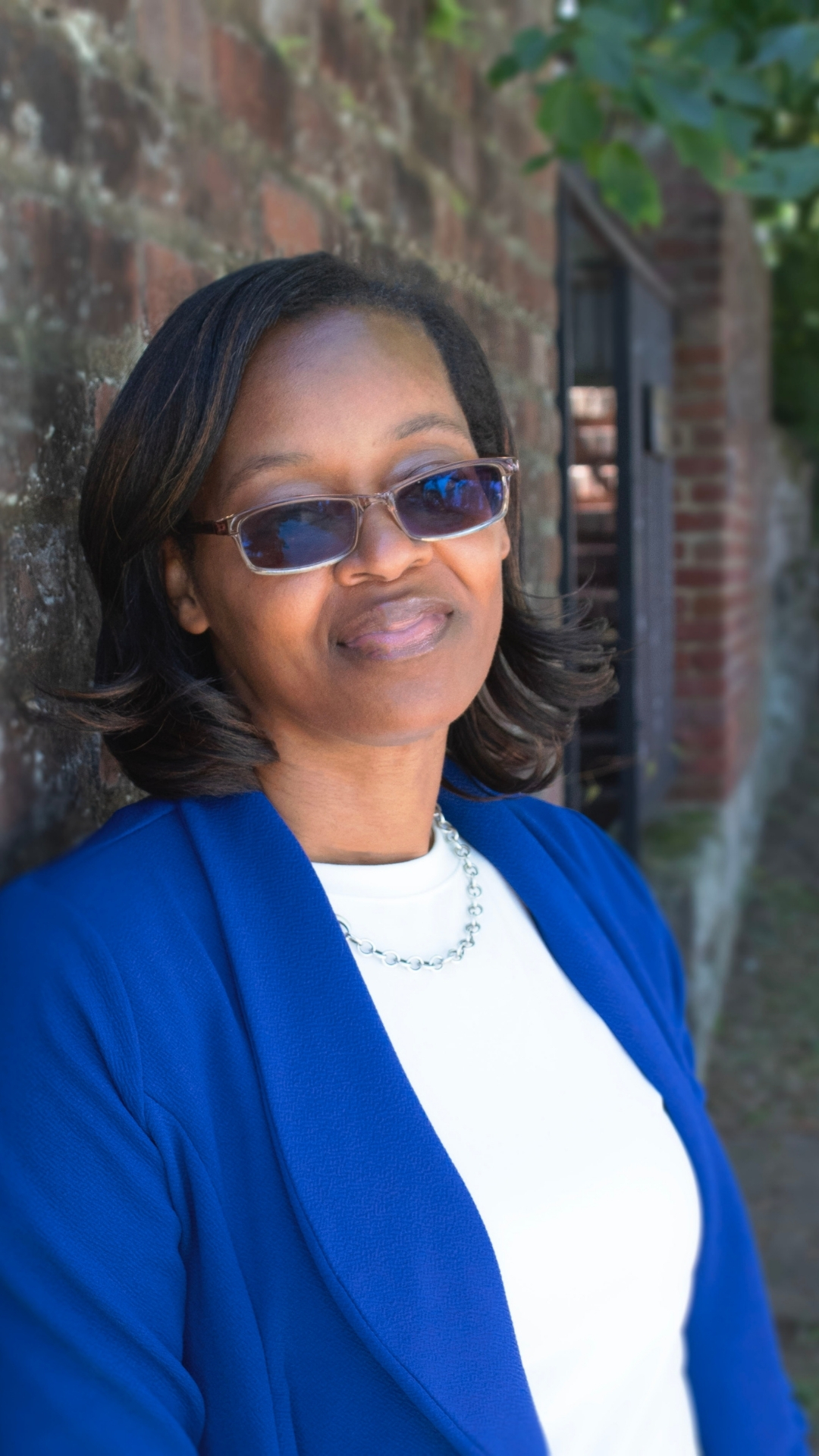 A photo f Kevin Milfeld - Board President of RISE Hybrid Academy in a blue suit and white shirt.