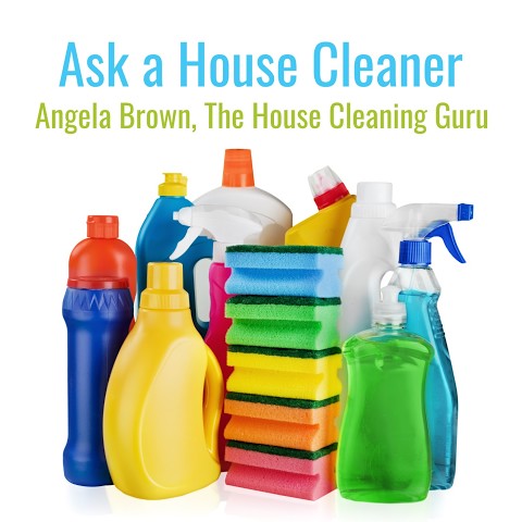 Stack of colorful cleaning sponges surrounded by various bottles of cleaning products with text 'Ask a House Cleaner, Angela Brown, The House Cleaning Guru' above.