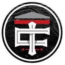 Circular logo with white stylized letters 'TCF', a red horizontal bar above, and two red stars below on a black textured background.
