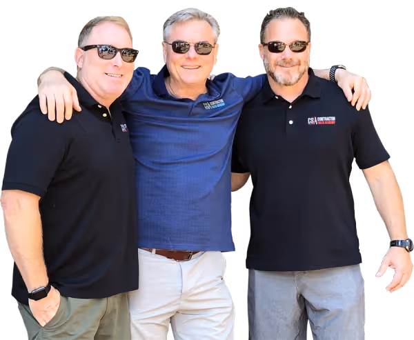 Three middle-aged men wearing sunglasses and casual polo shirts, standing with arms around each other and smiling.
