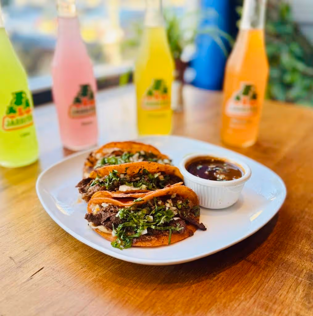 A plate of food with a white plate and a bowl of sauce.