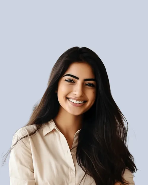 Smiling young woman with long dark hair wearing a beige button-up shirt against a light gray background.