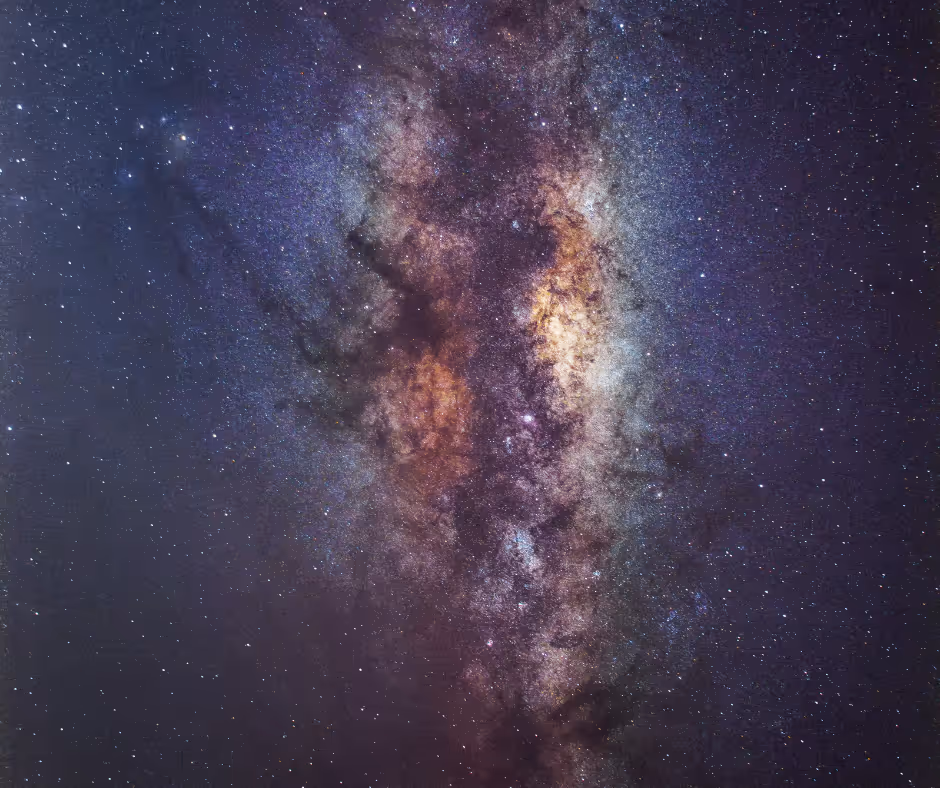 Detailed view of the Milky Way galaxy showing bright star clusters and dust clouds in a star-filled night sky.
