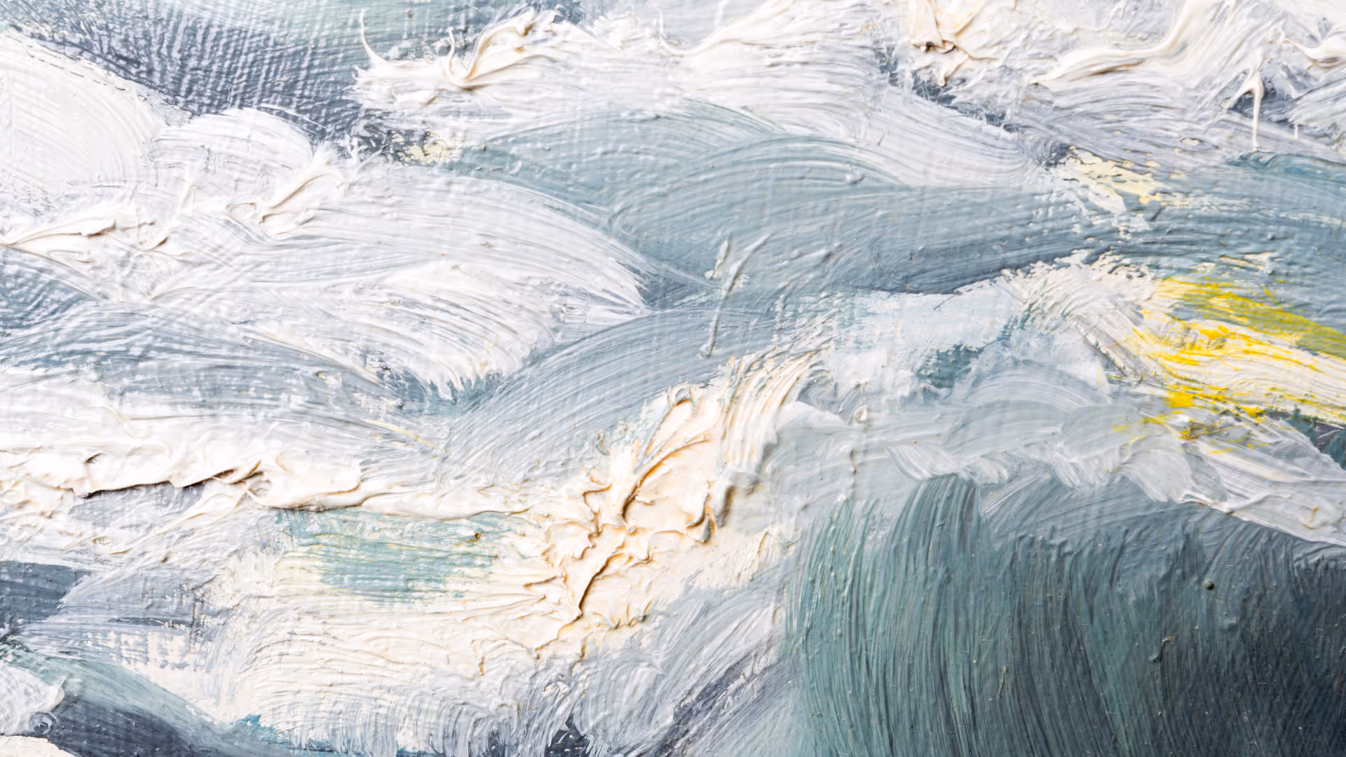 Close-up of thick textured paint strokes in white, gray, blue, and a touch of yellow on a canvas.