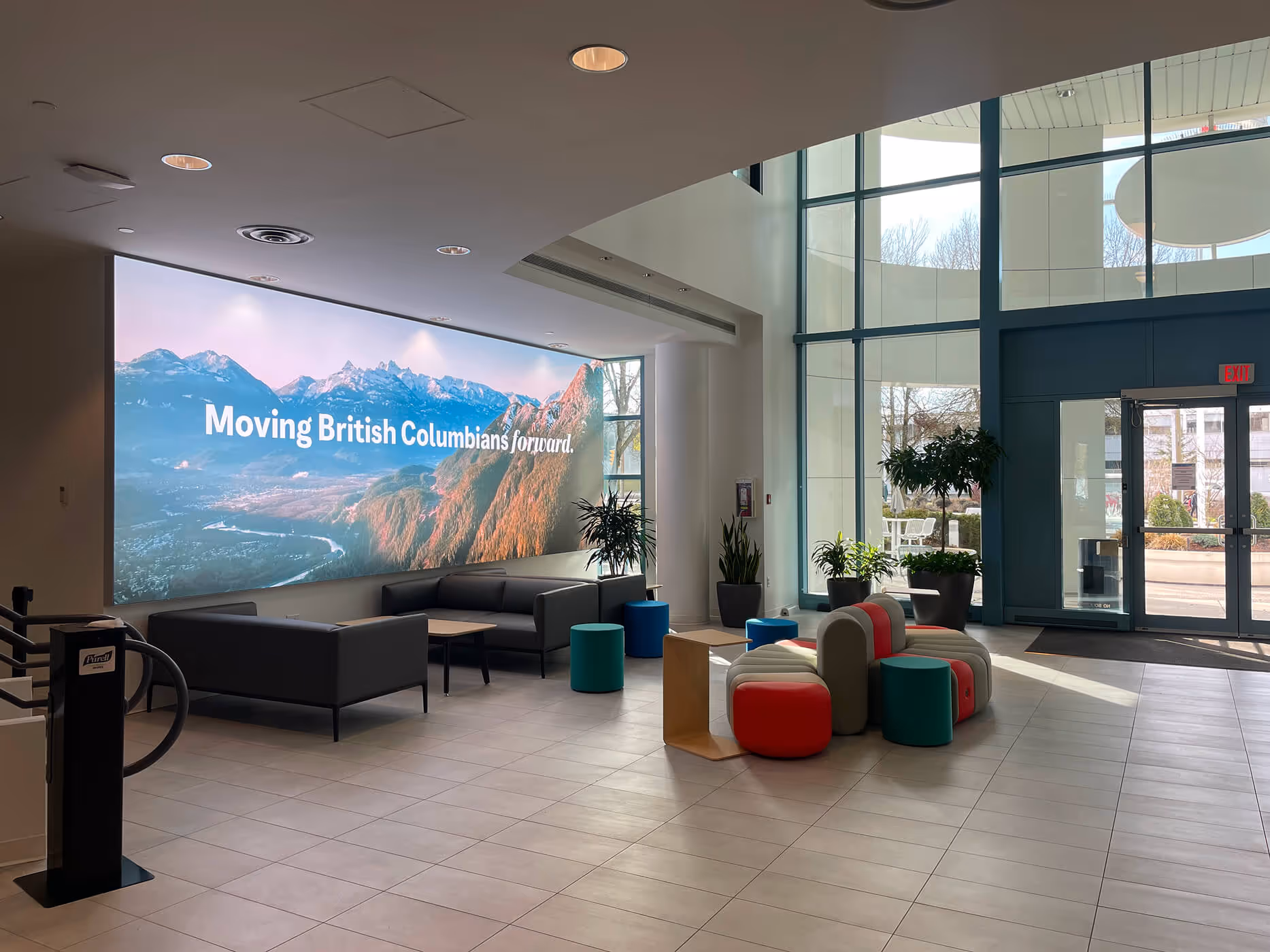 BCAA main lobby with an illuminated scenic wall graphic and modern modular seating.
