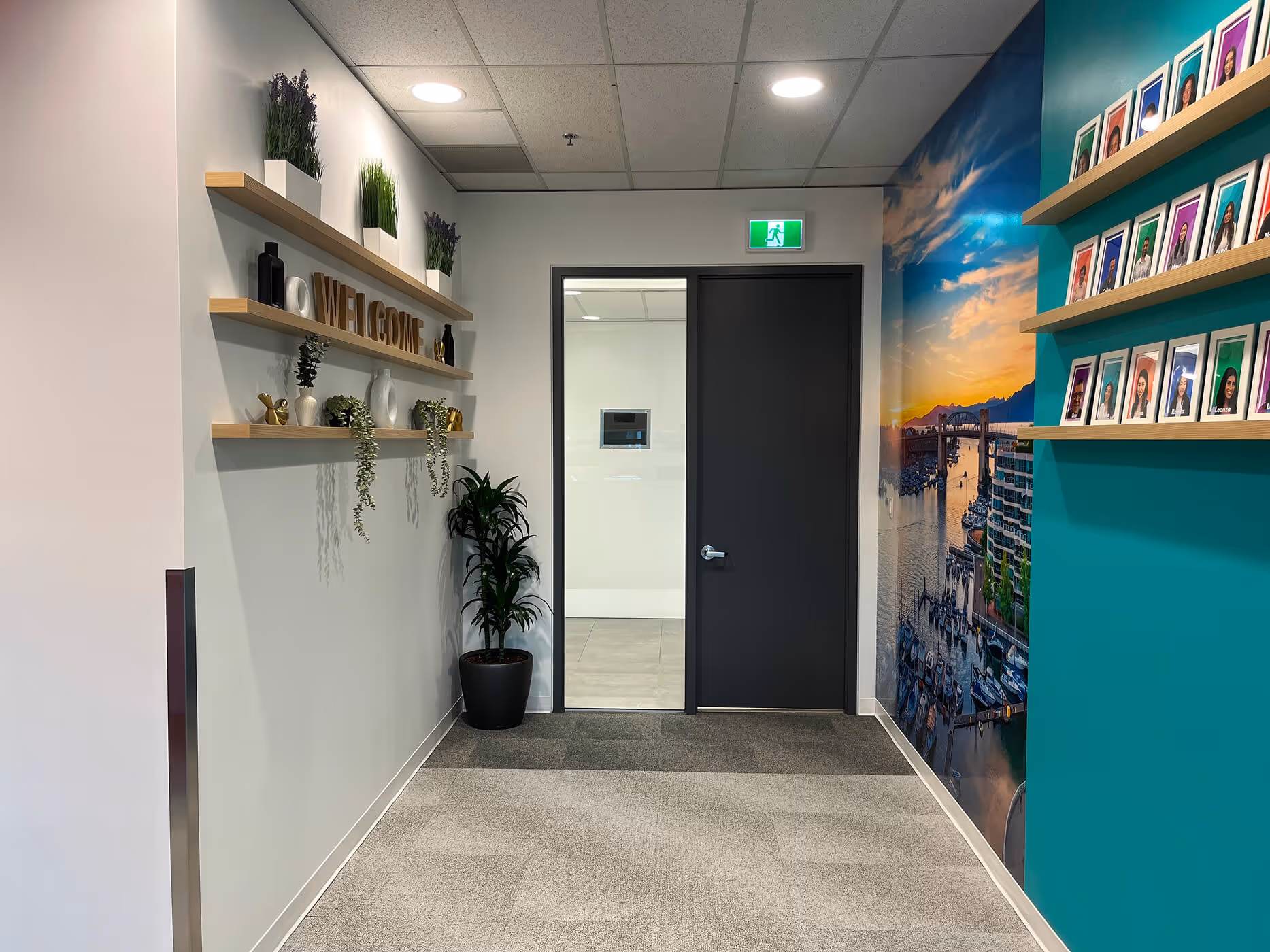 BCAA office hallway featuring decorative shelves and a large waterfront wall mural.