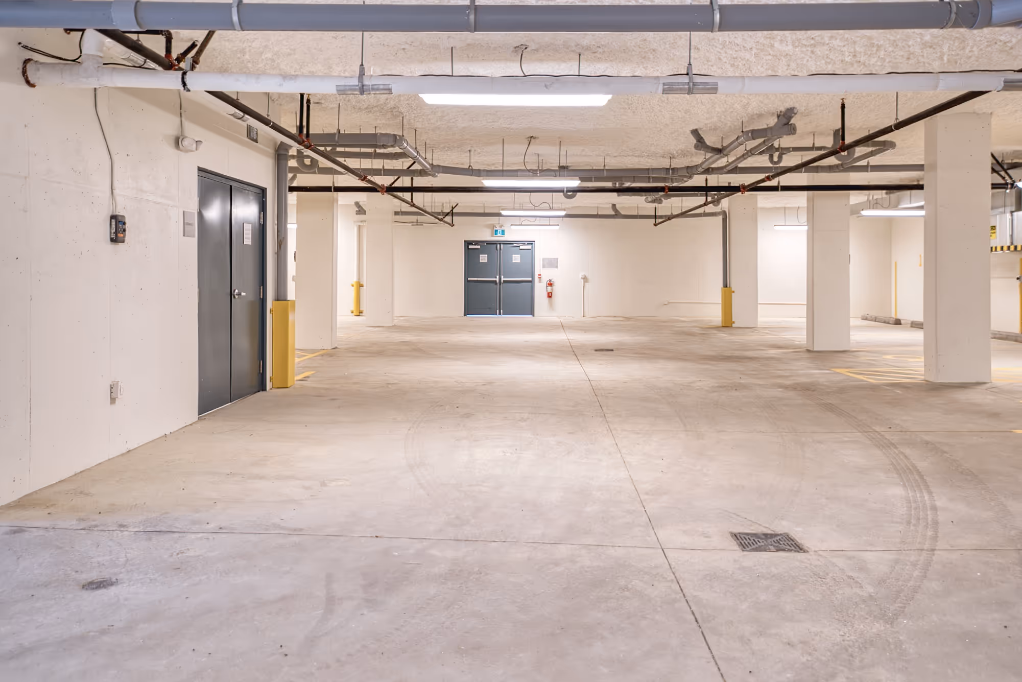 Underground parking garage at Lily Lake Place Seniors Housing with concrete columns and lighting.