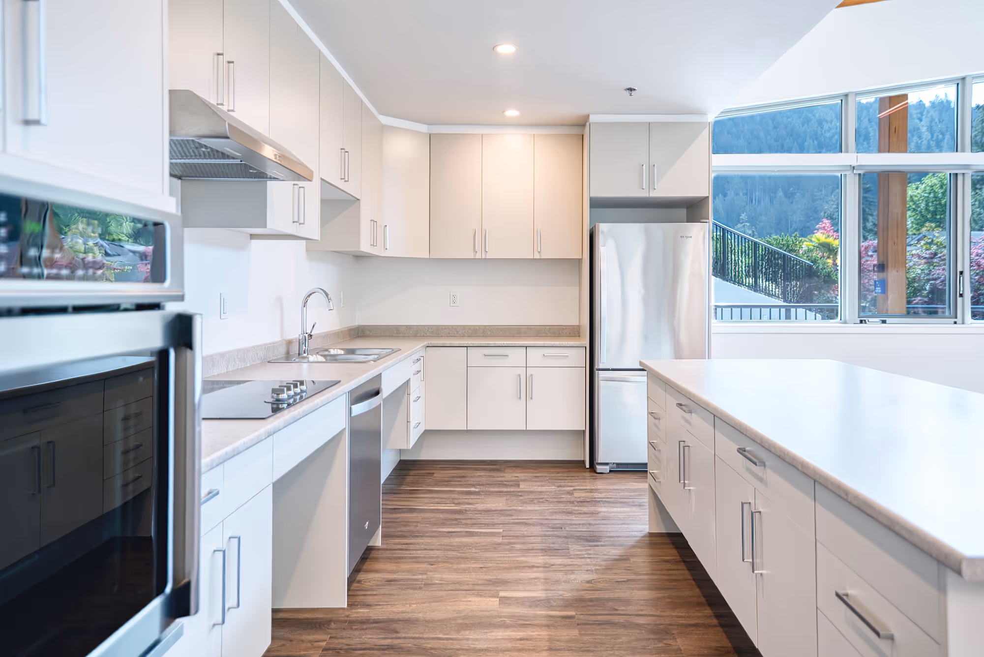 Kitchen interior at Lily Lake Place Seniors Housing with stainless steel appliances and light cabinetry.