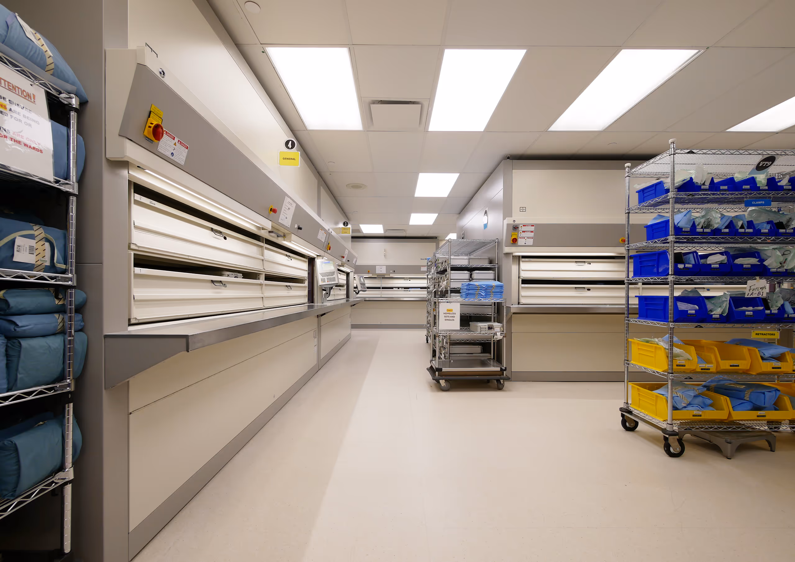 Clean workroom interior at Vancouver General Hospital MDRD renovation with casework and storage carts.