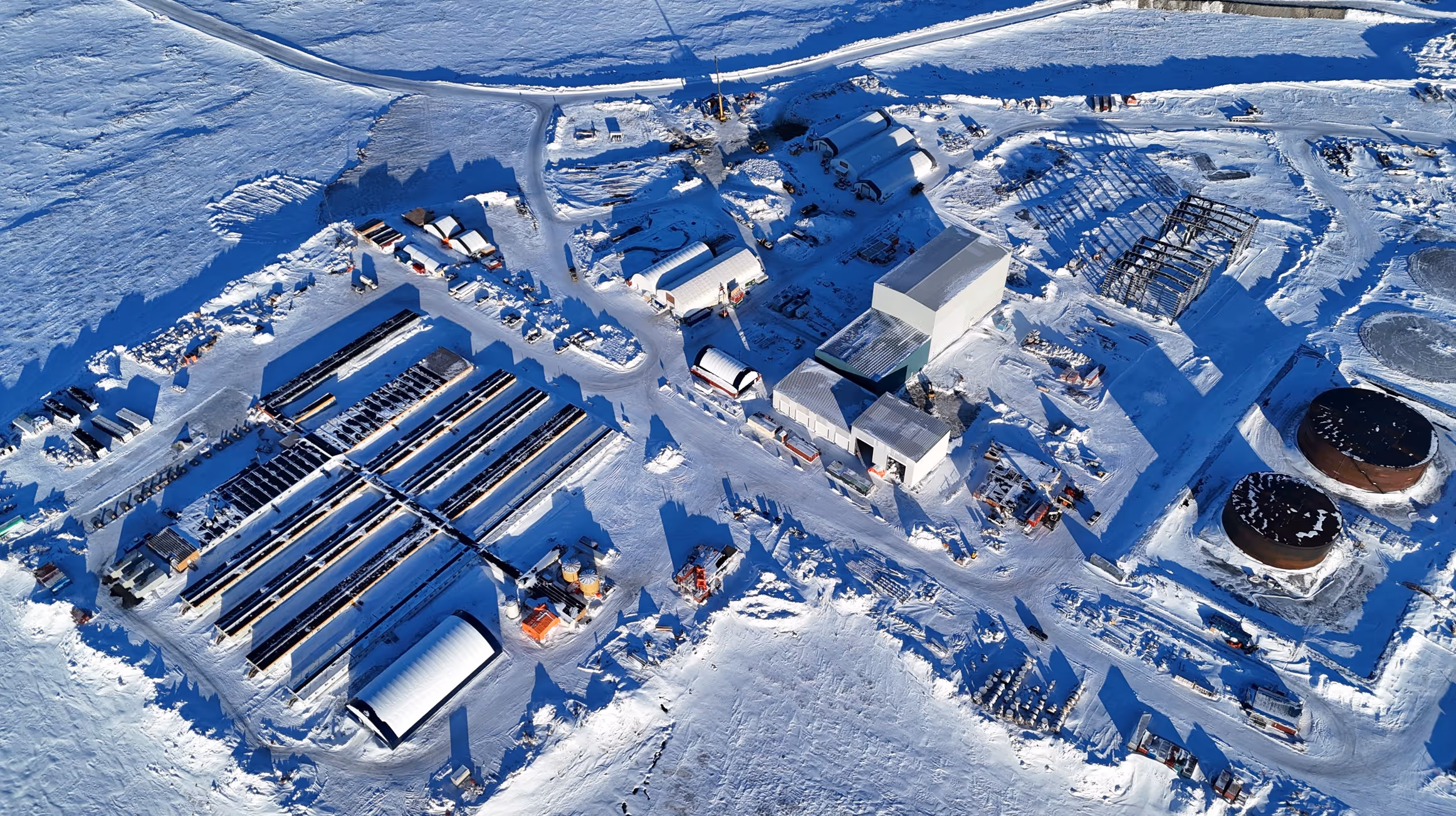 Aerial view of Goose Lake industrial facility showing buildings, equipment yards, and snow-covered terrain.