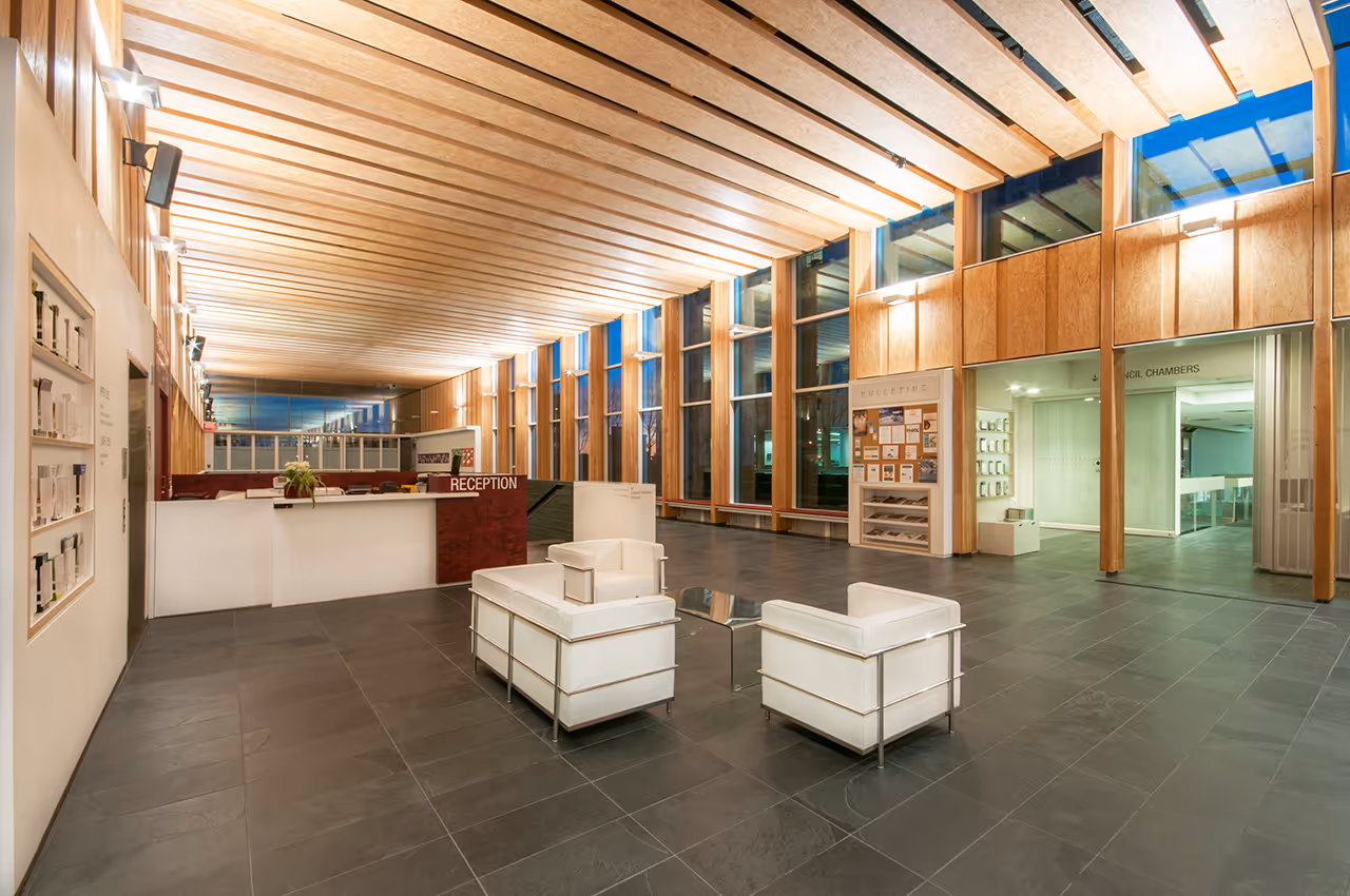 Atrium perspective at North Vancouver City Hall Redevelopment showing stair, glass railings, and wood ceiling.