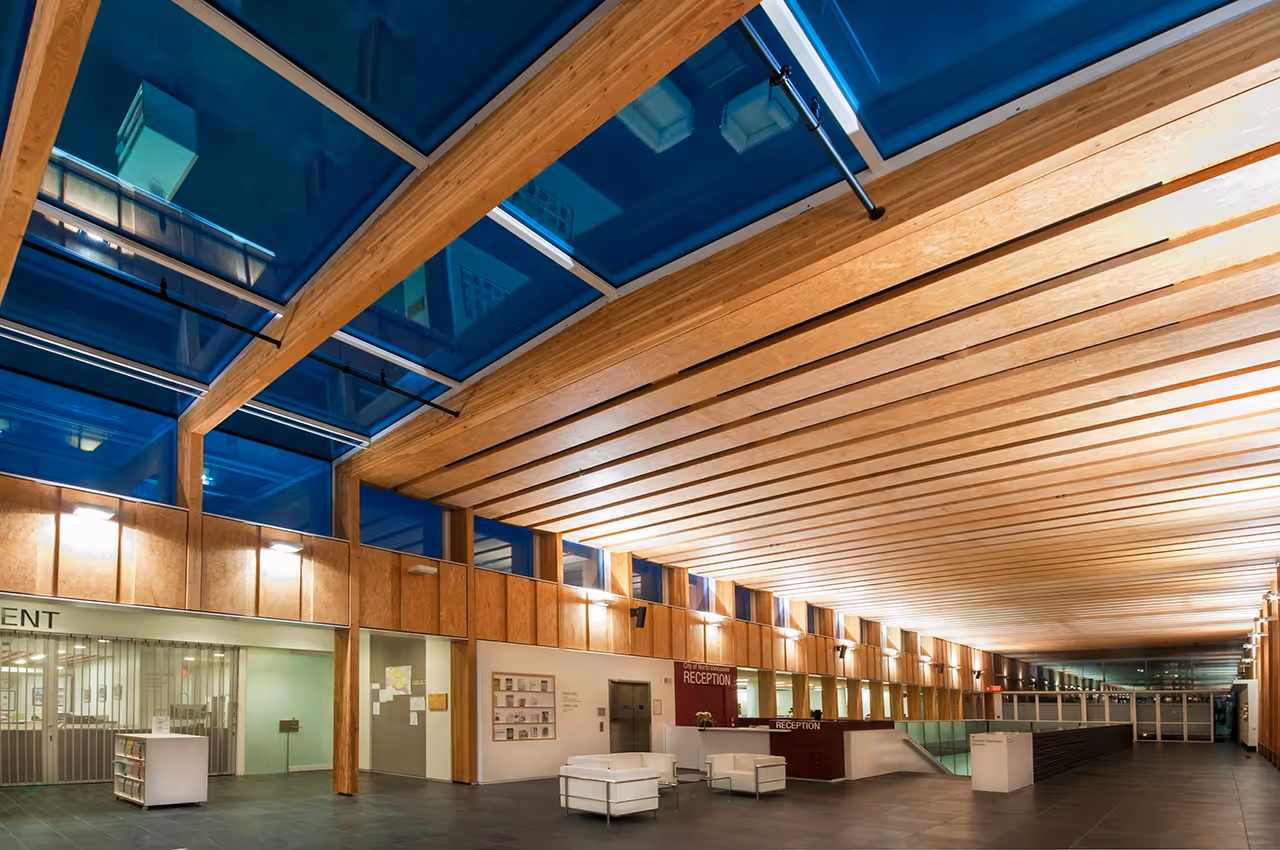 Central public hall at North Vancouver City Hall Redevelopment with skylight roof and wood structure.