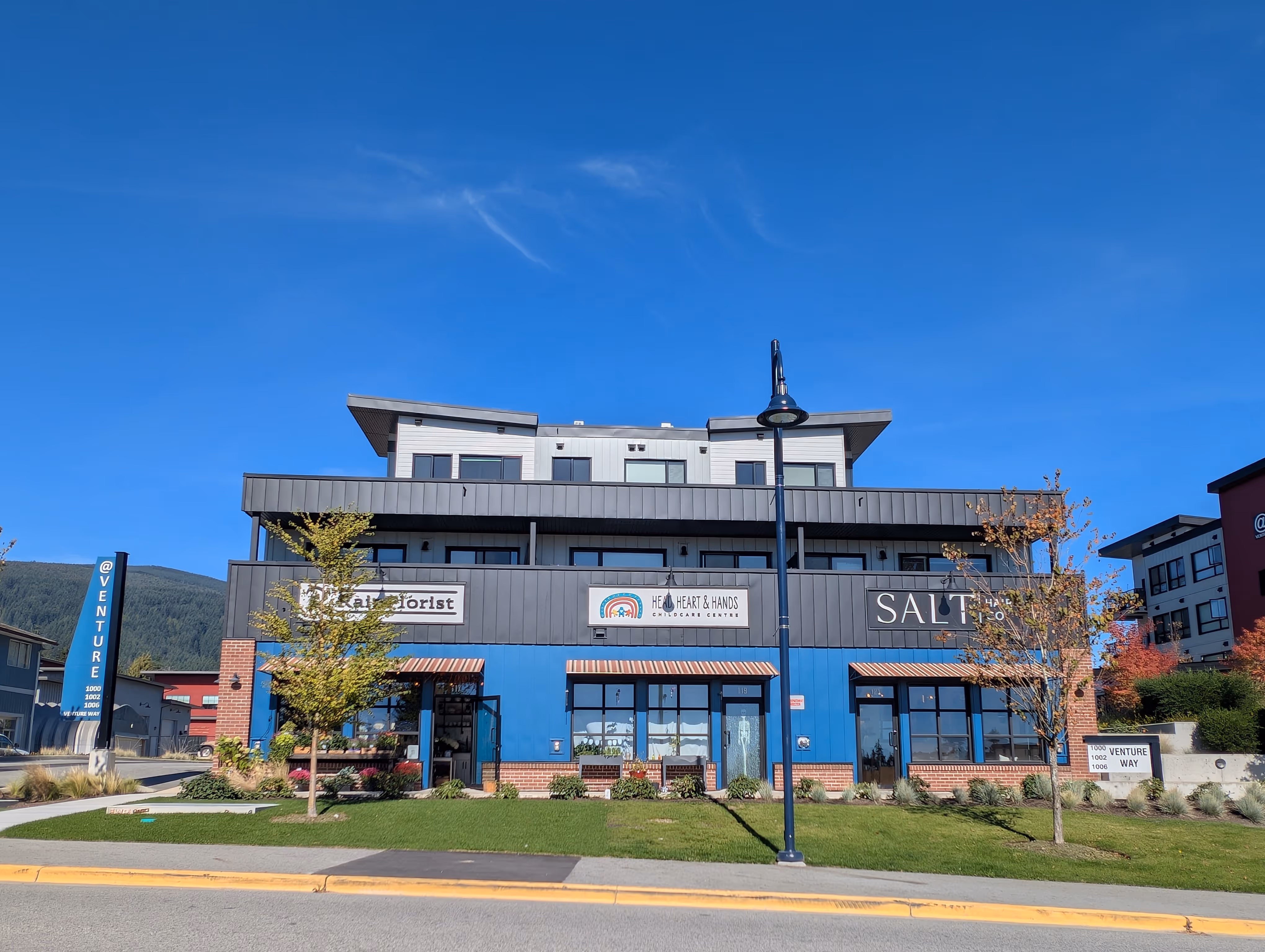 Parking court and completed buildings at Venture Industrial Village with integrated power distribution and site lighting systems.