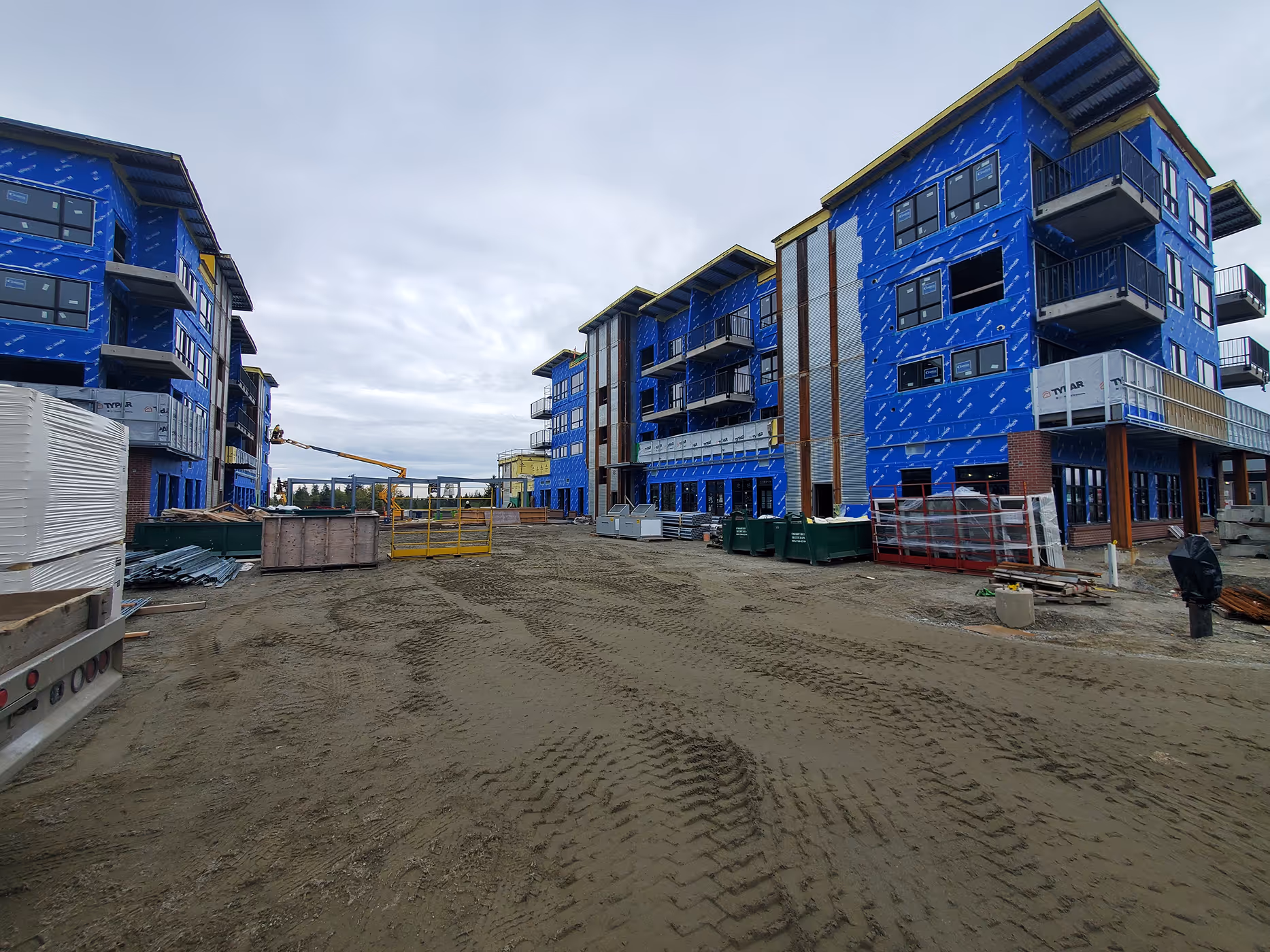 Venture Industrial Village under construction showing multi-storey residential and commercial buildings with coordinated electrical design by WEE.