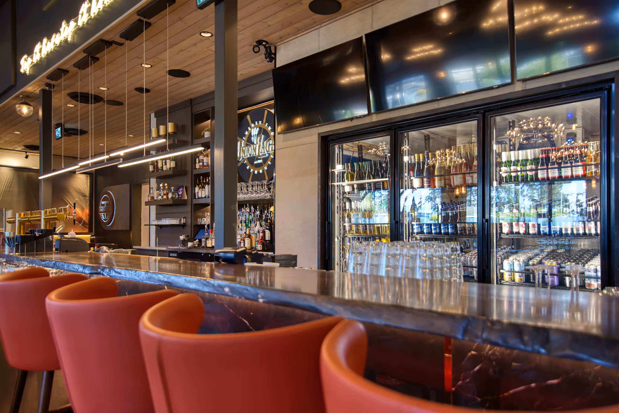 Bar counter and back-of-house lighting at Twenty Two Taphouse with commercial refrigeration display