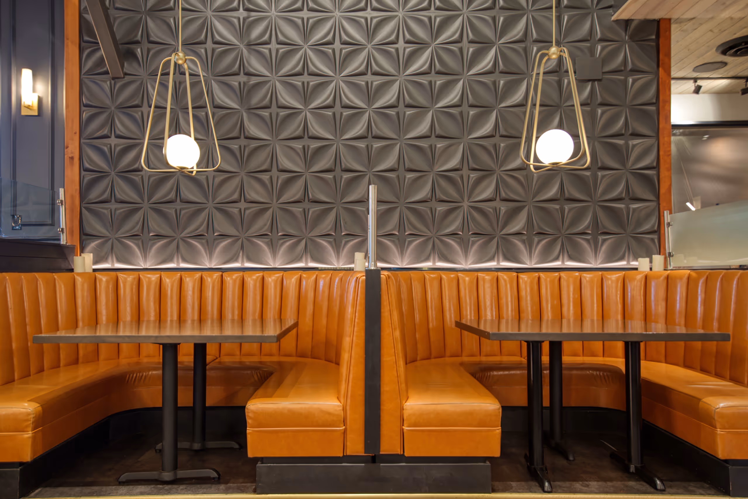 Leather booth seating with decorative pendant lighting at Twenty Two Taphouse restaurant