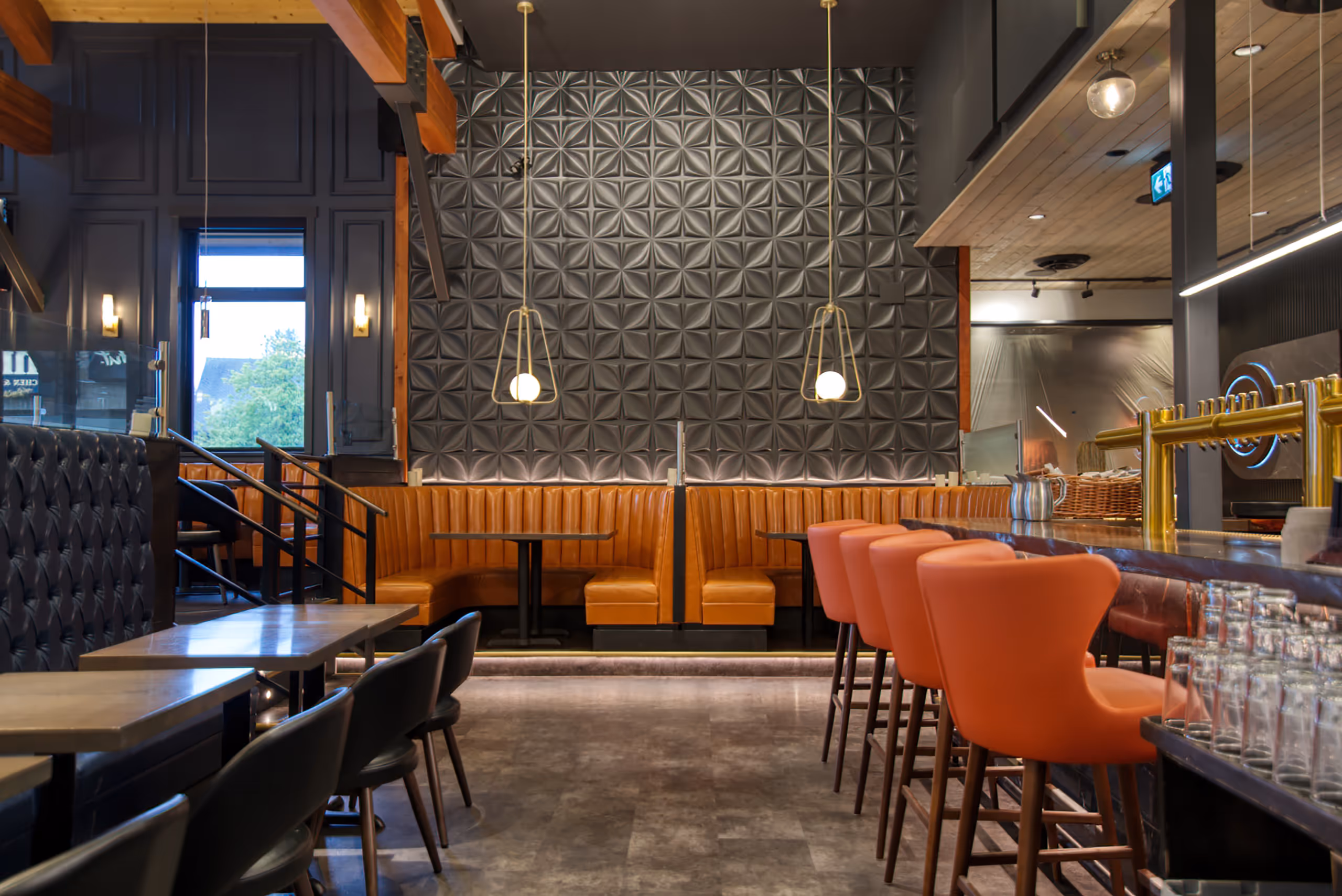 Restaurant dining area with custom pendant lighting and booth seating at Twenty Two Taphouse