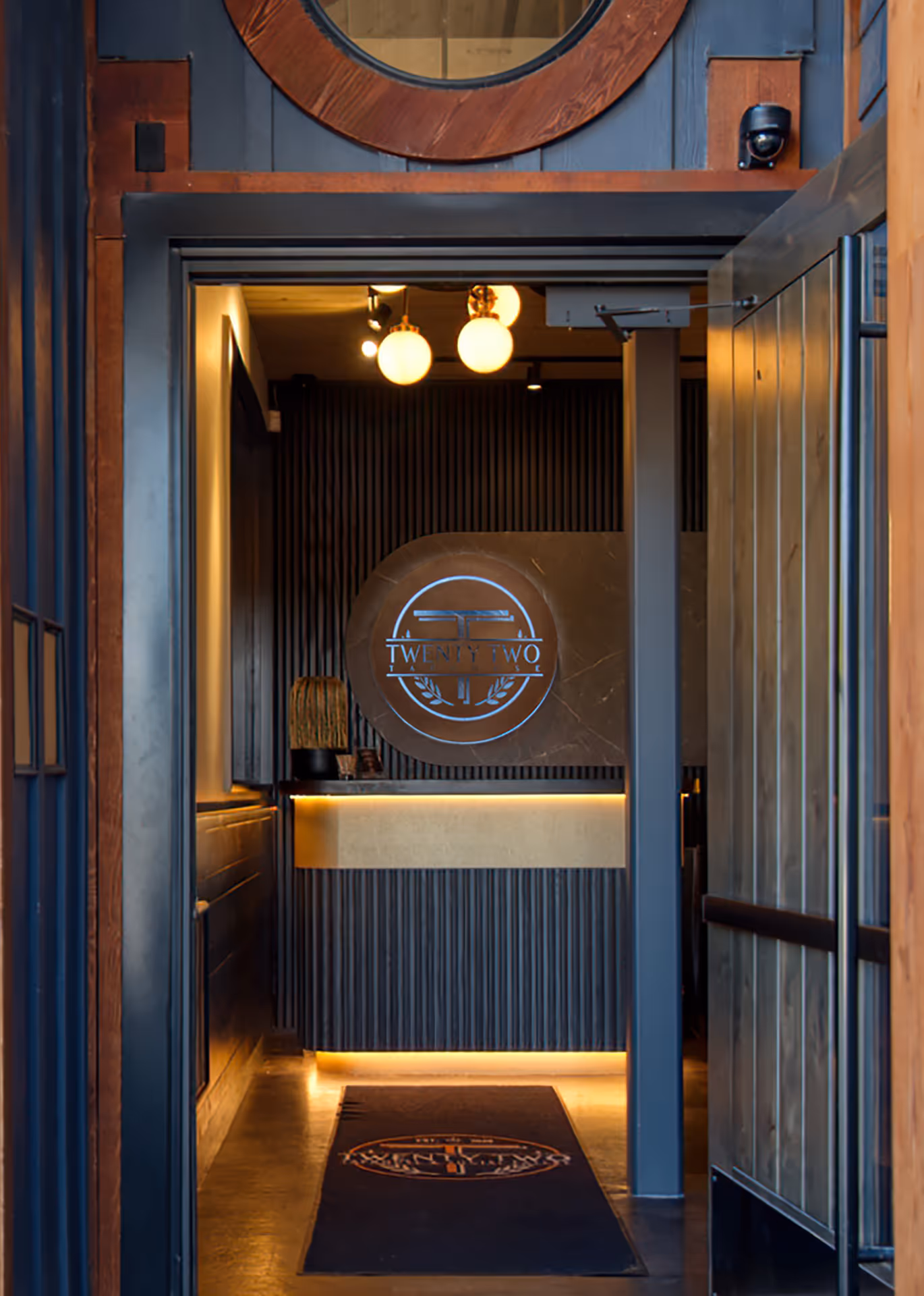 Entrance to Twenty Two Taphouse showing illuminated reception desk and interior lighting design