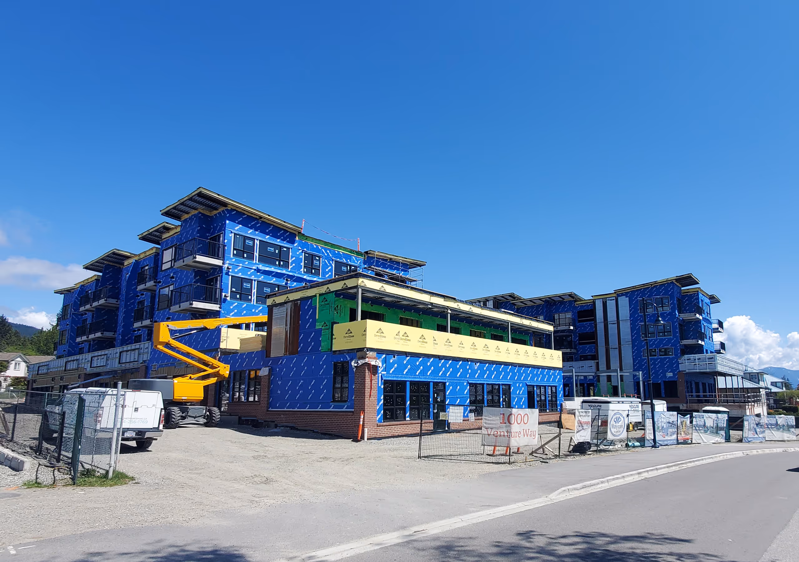 Exterior of Venture Industrial Village during construction with integrated electrical systems across residential, commercial, and industrial spaces.