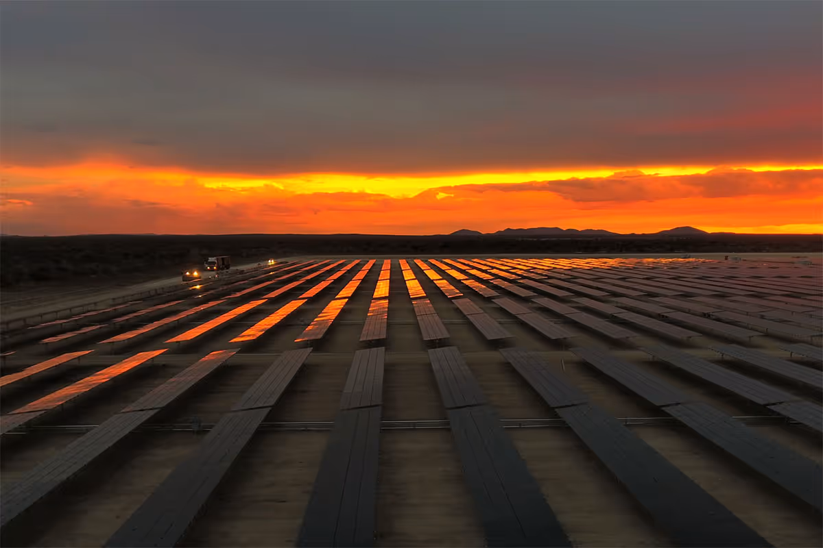 Solar photovoltaic array at the Otjikoto Mine in Namibia illuminated by sunset sky