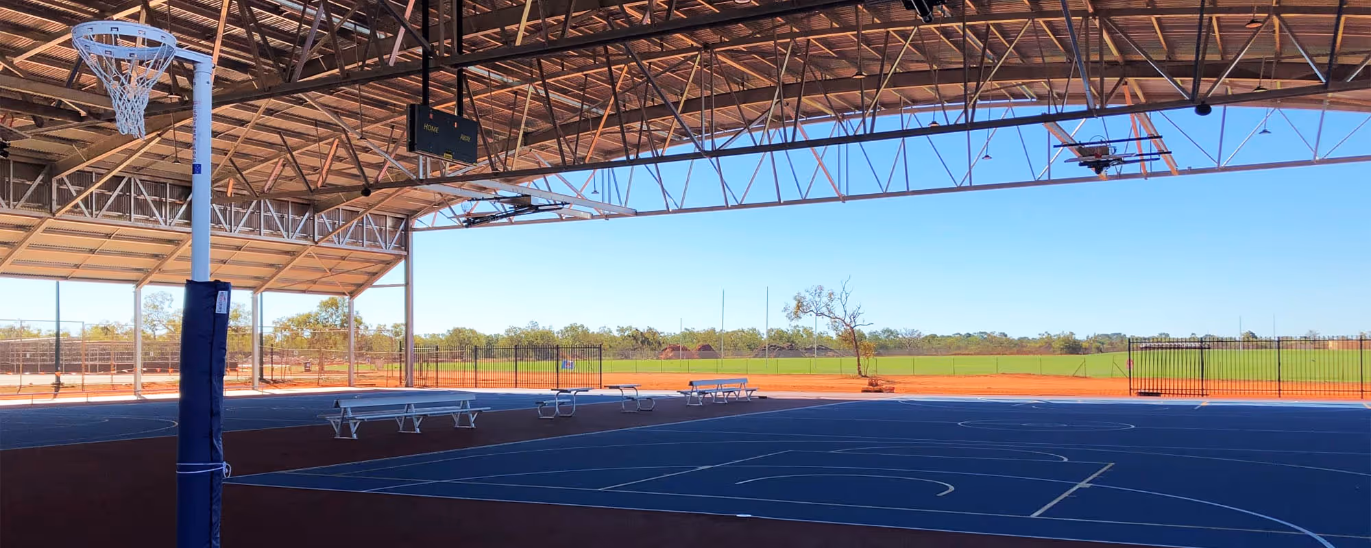 Cyclone-rated 4,000m² steel canopy covering four outdoor netball courts at the Broome Recreation and Aquatic Centre.