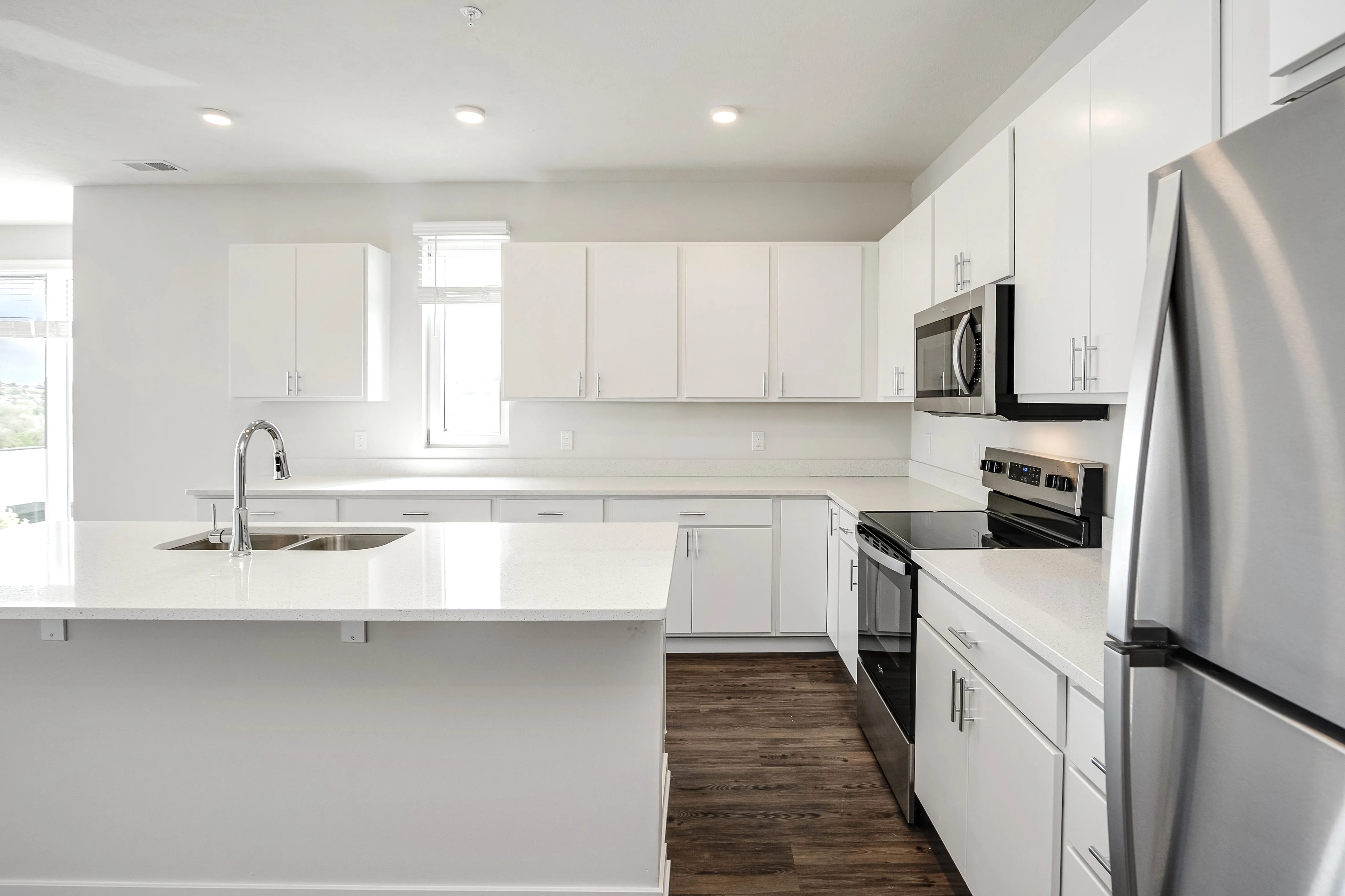 Kitchen with white countertops and stainless steel appliances 