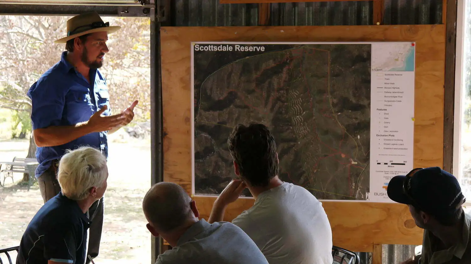 Group of NRM stakeholders engaged in discussion during a community consultation event