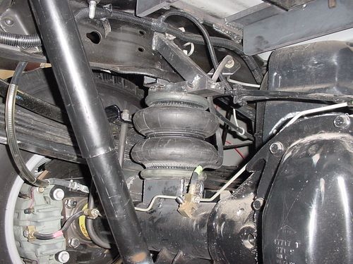 Ride Rite air helper springs installed on a truck suspension for weight control.