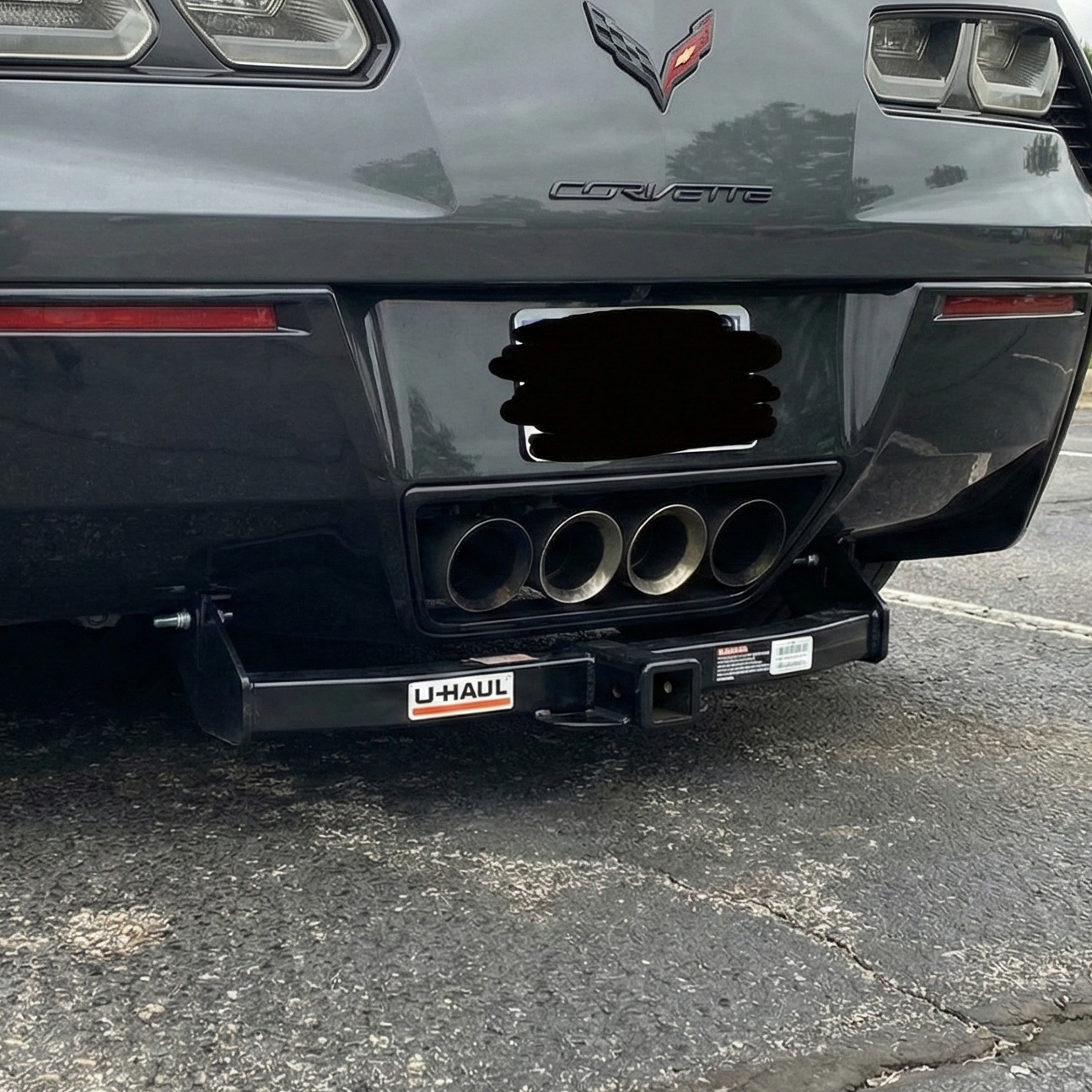 Example of a luxury sports car with a u-haul hitch hanging too low. This car needs a hidden hitch to maintain its aesthetic design.
