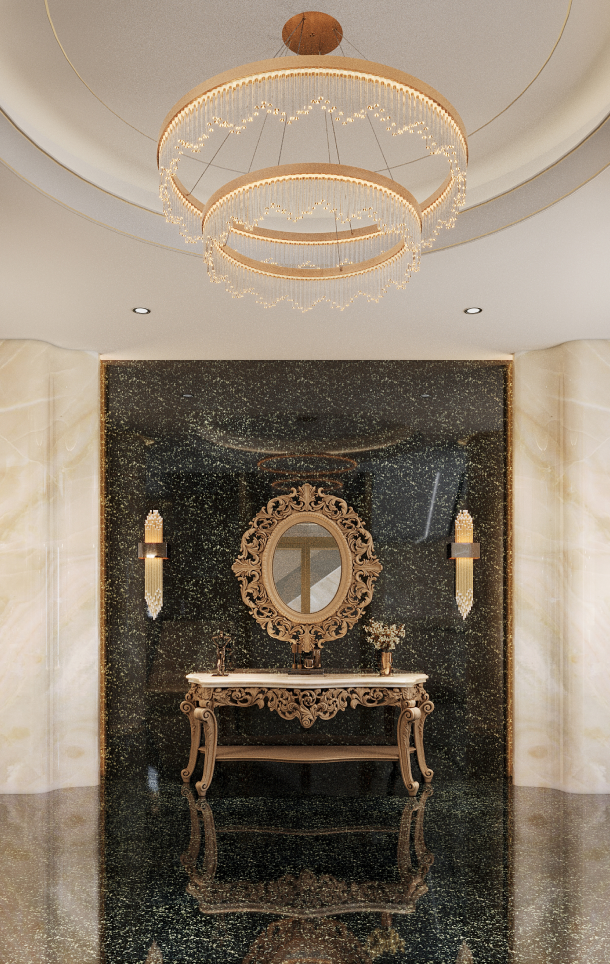 Elegant interior featuring a gold ornate oval mirror above a matching carved console table with floral decor, set against a glossy black marble wall with two crystal wall sconces and a modern dual-ring chandelier overhead.
