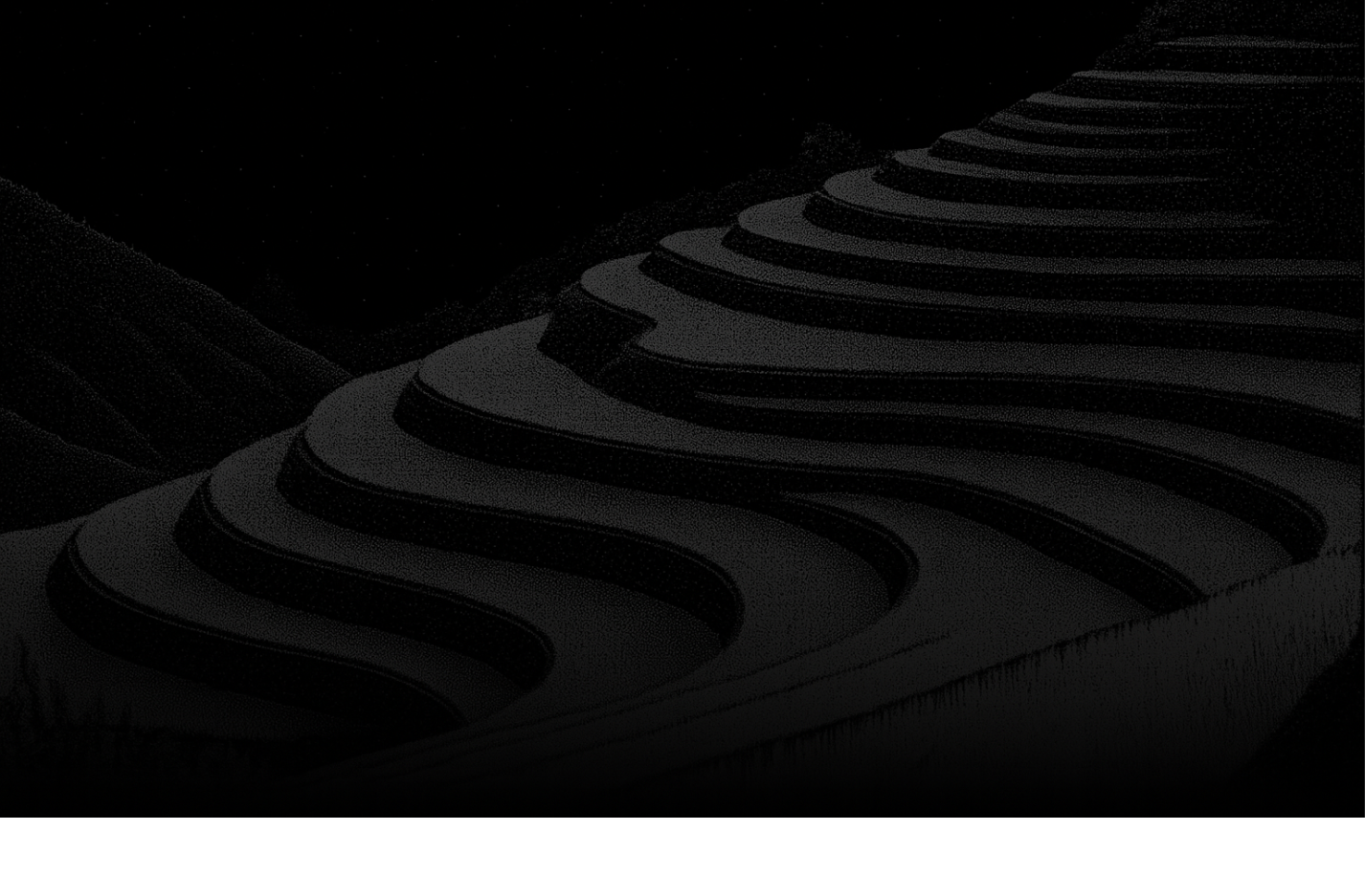 Terraced agricultural hillside with curved farming terraces at dusk or night.