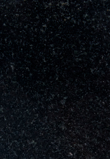 Close-up of polished black granite surface with subtle gray and white speckled patterns.