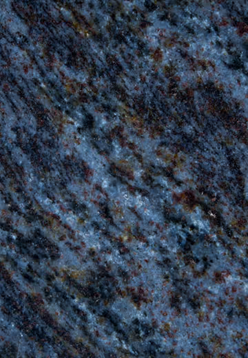 Close-up of dark blue granite stone surface with subtle reddish and yellowish mineral specks.