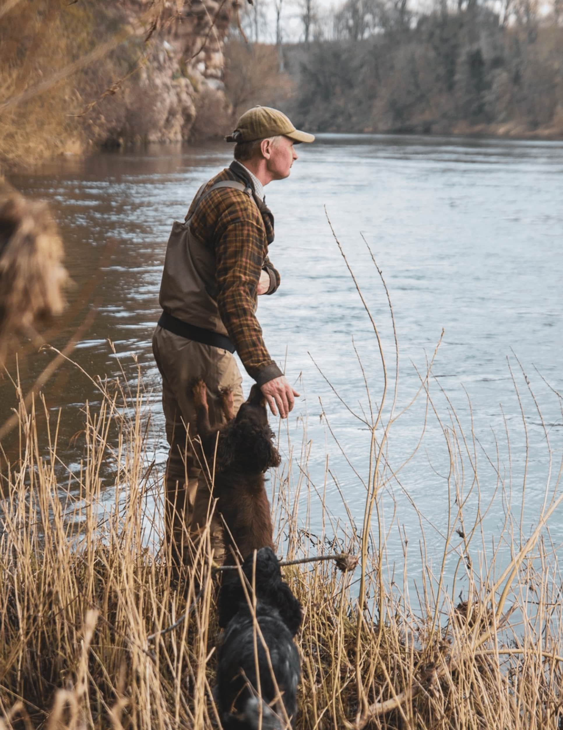 Angler standing beside the River Tweed