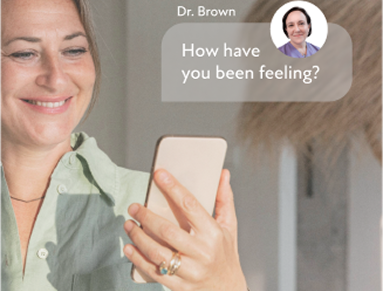 Smiling woman holding a smartphone with a message from Dr. Brown asking, 'How have you been feeling?'