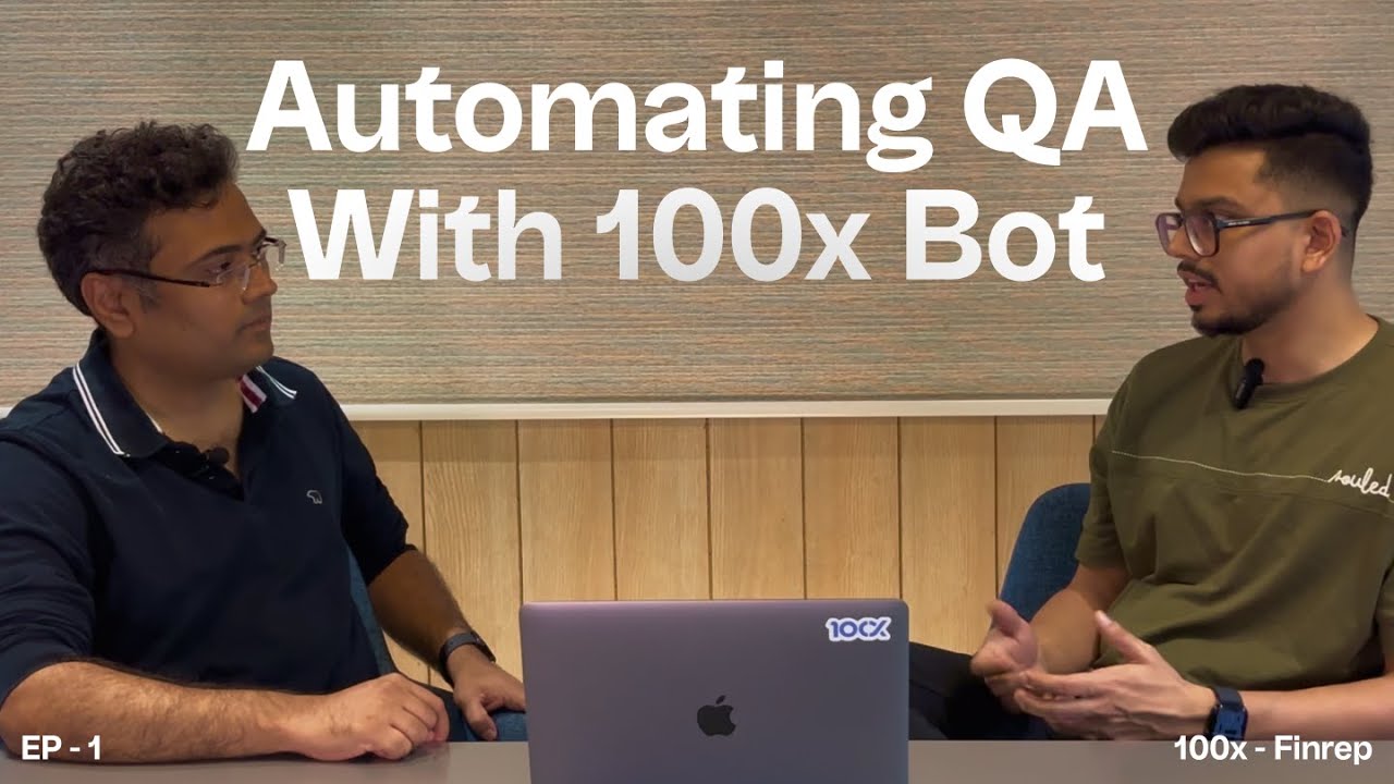 Two men sitting at a table with a laptop between them, discussing with the text 'Automating QA With 100x Bot' on the wall behind.