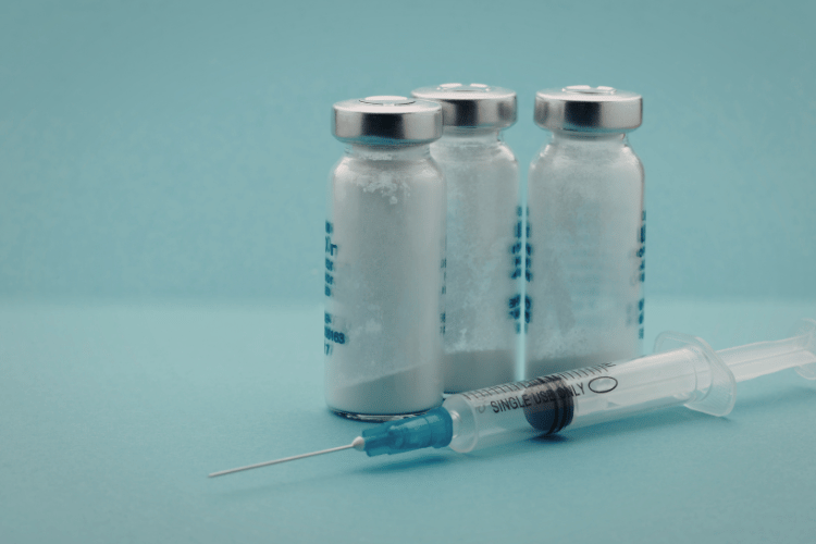 Frosted sermorelin vials with condensation and syringe, indicating improper storage or potential peptide degradation.
