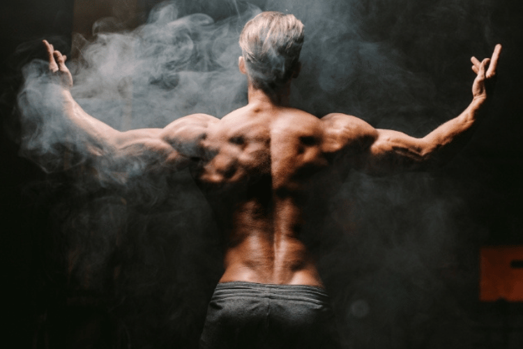 Athletic older man shown from behind with defined back and shoulder muscles, representing Sermorelin vs NAD+ therapy for men’s health, recovery, performance, and healthy aging.