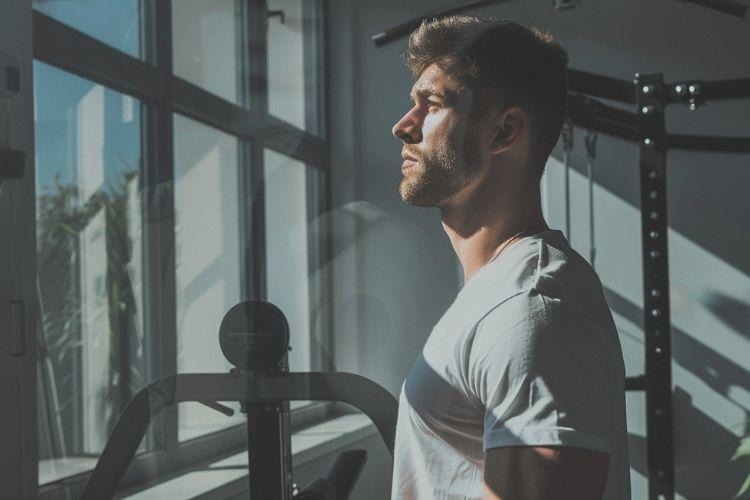 Man improving body composition and lean muscle mass through peptide therapy and fitness training.