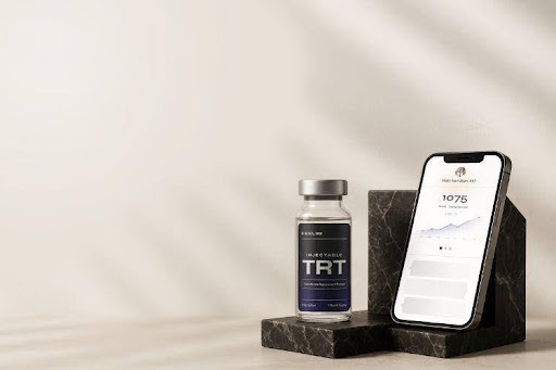 Feel30 injectable TRT vial beside a smartphone displaying a testosterone levels chart
